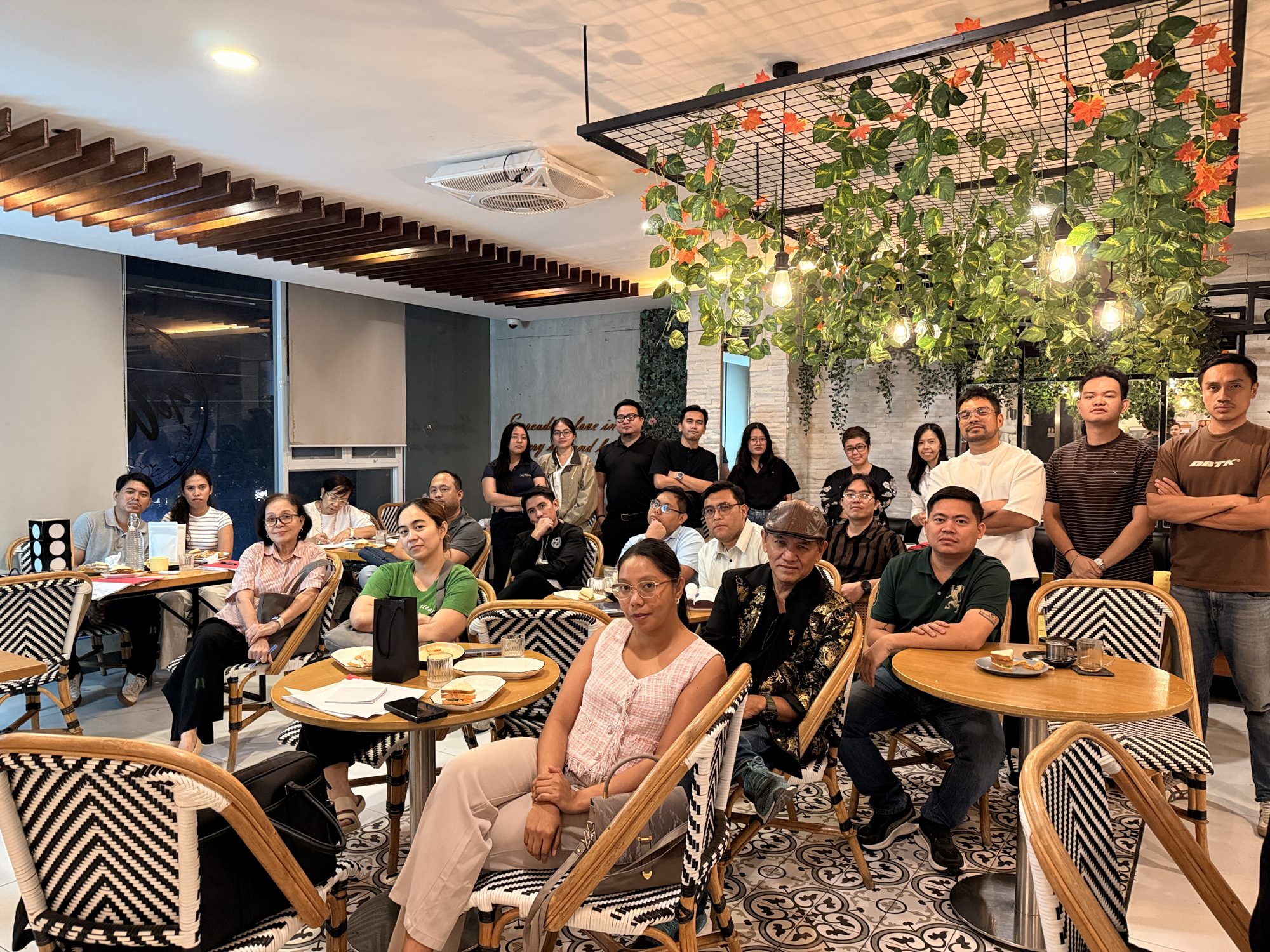 A full room of Cebu South Toastmasters members and guests smiling at Te'Amo Café